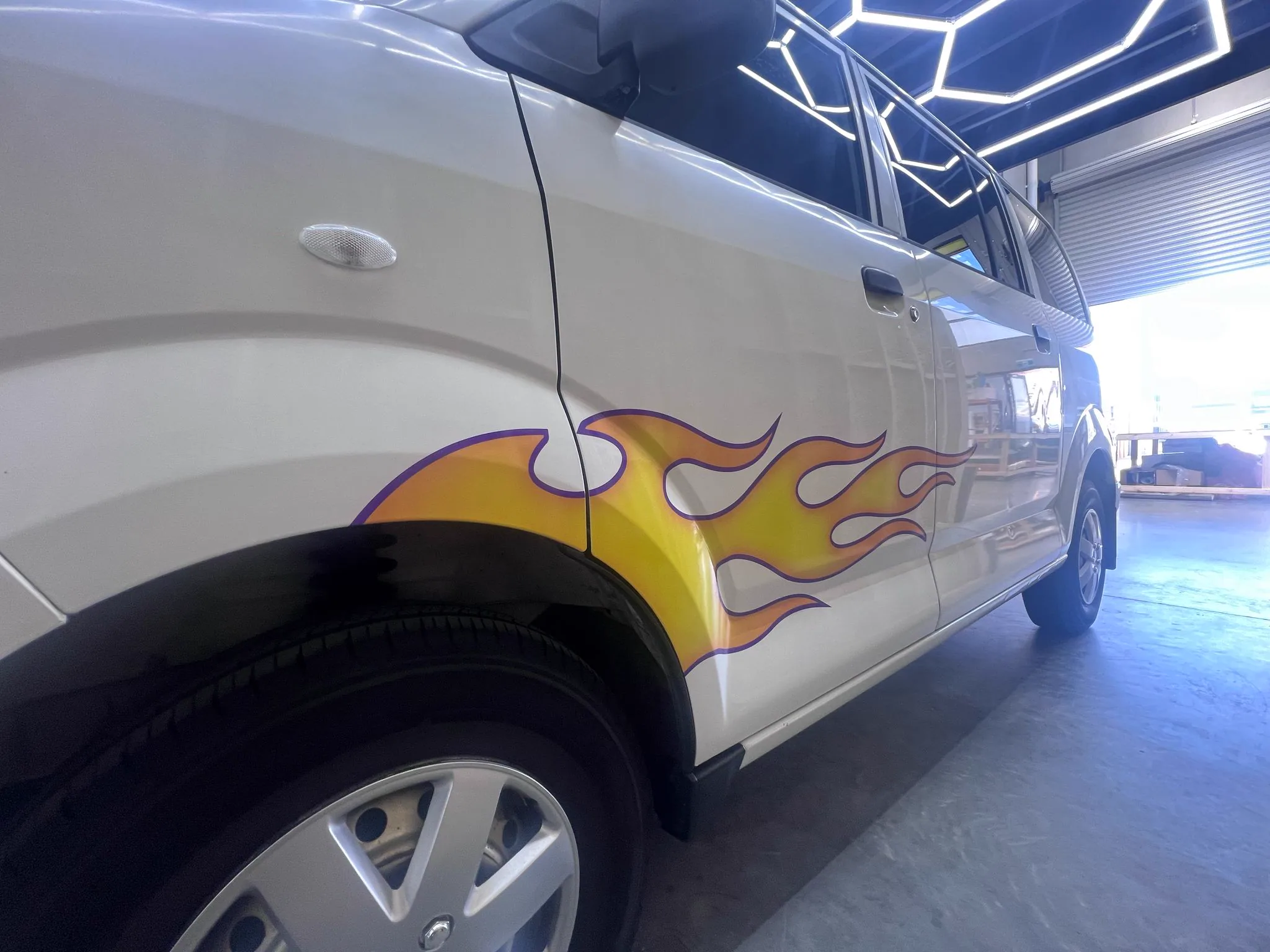 Printed flame accent wrap on a vehicle side